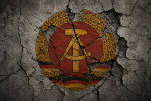 Zersetzung in der DDR: Rissiges DDR-Wappen als Symbol für politische Verfolgung und psychologische Repression durch die Stasi