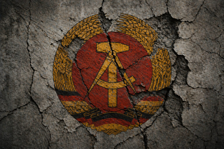 Zersetzung in der DDR: Rissiges DDR-Wappen als Symbol für politische Verfolgung und psychologische Repression durch die Stasi
